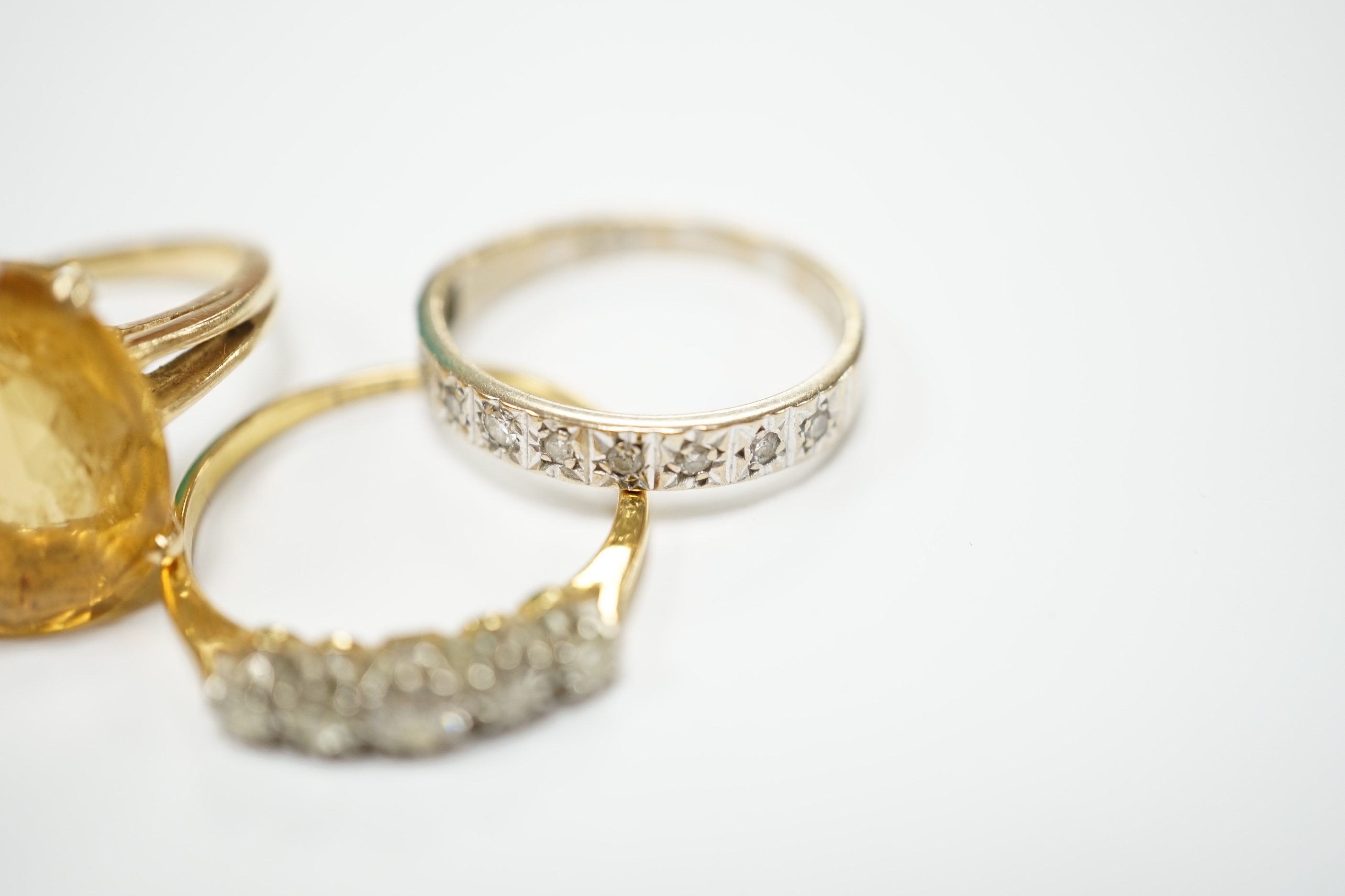An 18ct and graduated five stone diamond set half hoop ring, size P/Q, one other 18ct and diamond chip set half hoop ring, gross weight 4.8 grams and a 14k and citrine set dress ring, gross weight 5.4 grams.